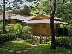 Roji leading to the Seigetsu chashitsu at Ise Jingū; typical features include the stepping stones, moss, bamboo gate, and division into outer and inner gardens.