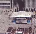 One of the last known photographs of the original memorial, seen below the Marriott Hotel on the left, during the September 11 attacks.